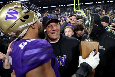 Washington head coach Kalen DeBoer celebrates with offensive lineman after defeating Washington State, 24-21, to capture the 115th Apple Cup, at Husky Stadium on Saturday, Nov. 25, 2023, in Seattle.