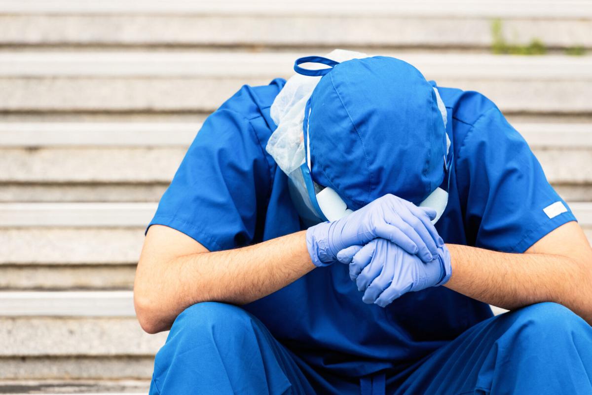 Serious, overworked, very sad male health care worker