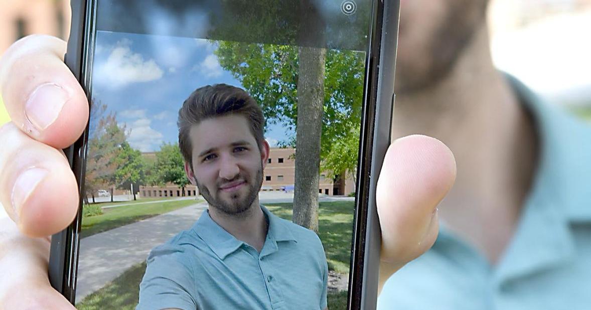 Josh Liljenquist pictured on a phone in the Mankato Free Press profile