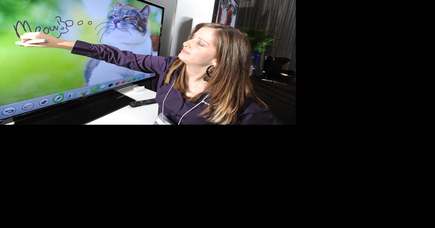 Is she writing on a TV screen?