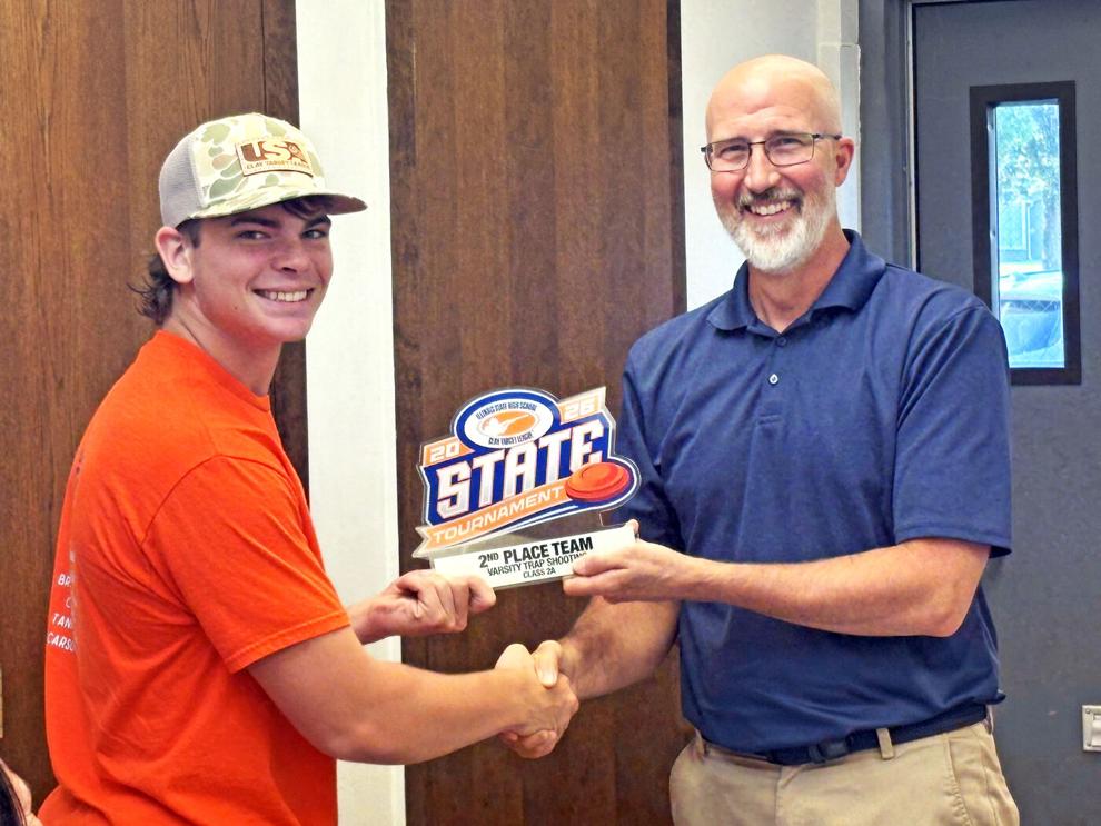 Claybusters present state trophy to Illini West High School