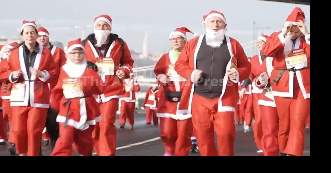 Thousands of runners in Santa costumes jog the streets of Budapest