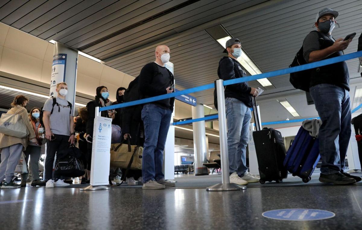 Air travelers line up to board an American Airlines flight to Jackson Hole, Wyoming, at O'Hare International Airport on March 11, 2021.