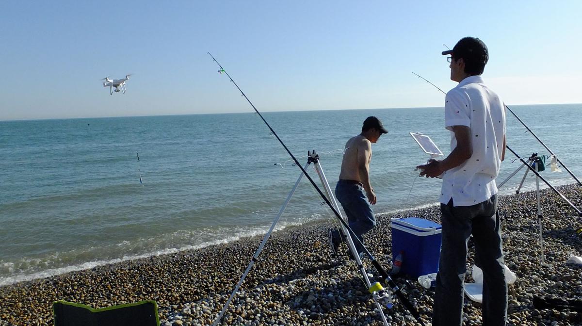 A fisherman uses a drone to sent his tackle out into the water