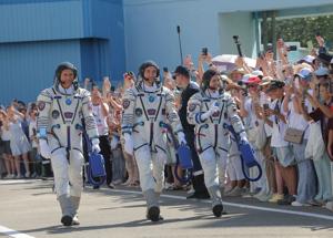 Russia sends American, two cosmonauts to space station