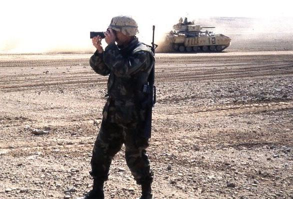 Desert Storm, 103rd PAO, MTARNG, attached to the 3rd Armored Cavalry Regiment photographing tanks moving forward prior to the invasion of Iraq.jpeg