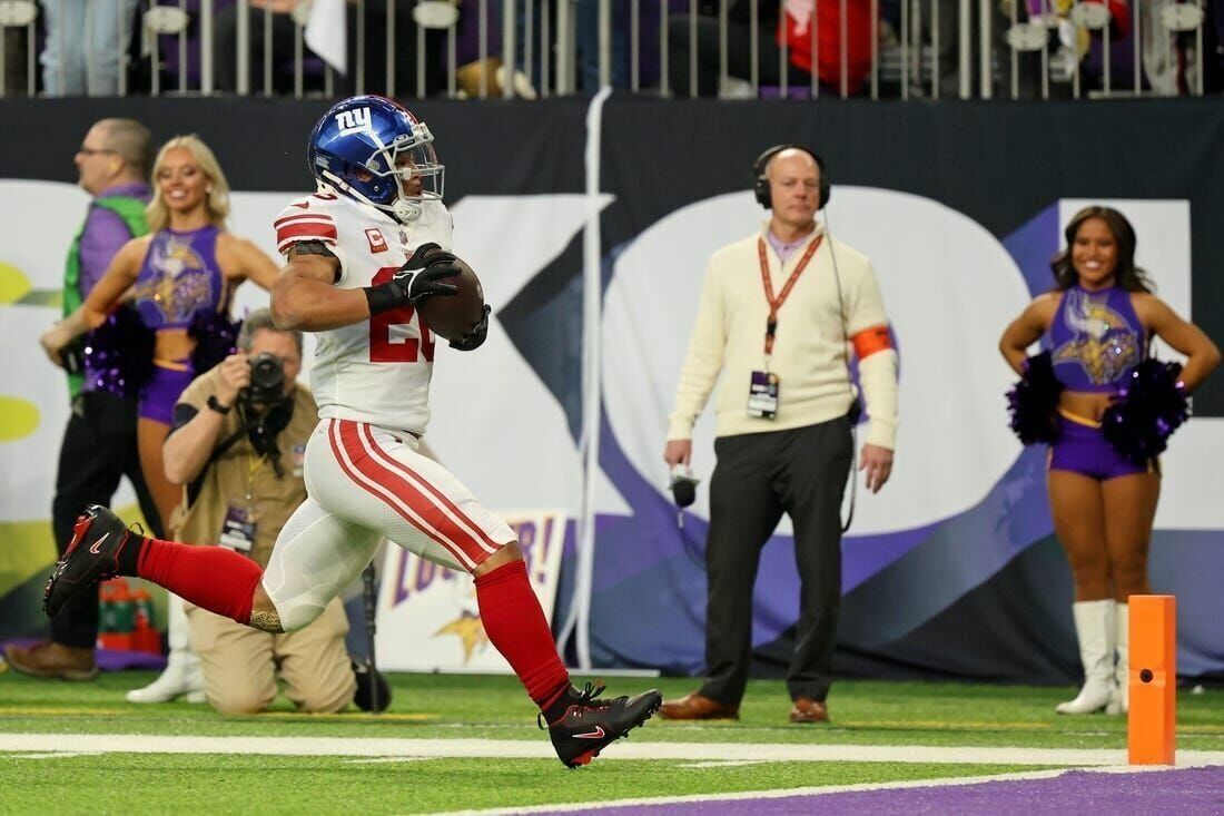 New York Giants running back Saquon Barkley (26) runs up field during the  first half of an NFL wild card playoff football game against the Minnesota  Vikings, Sunday, Jan. 15, 2023, in