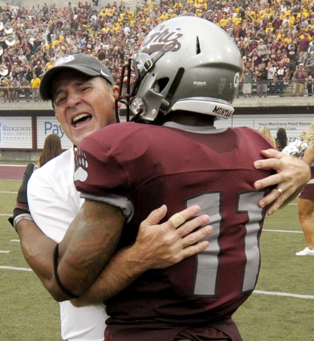 Montana head coach Bob Stitt hugs cornerback Nate Harris after the game. The victory over North Dakota State was Stitt’s first game as head coach for the Grizzlies. (Tom Bauer/The Missoulian)