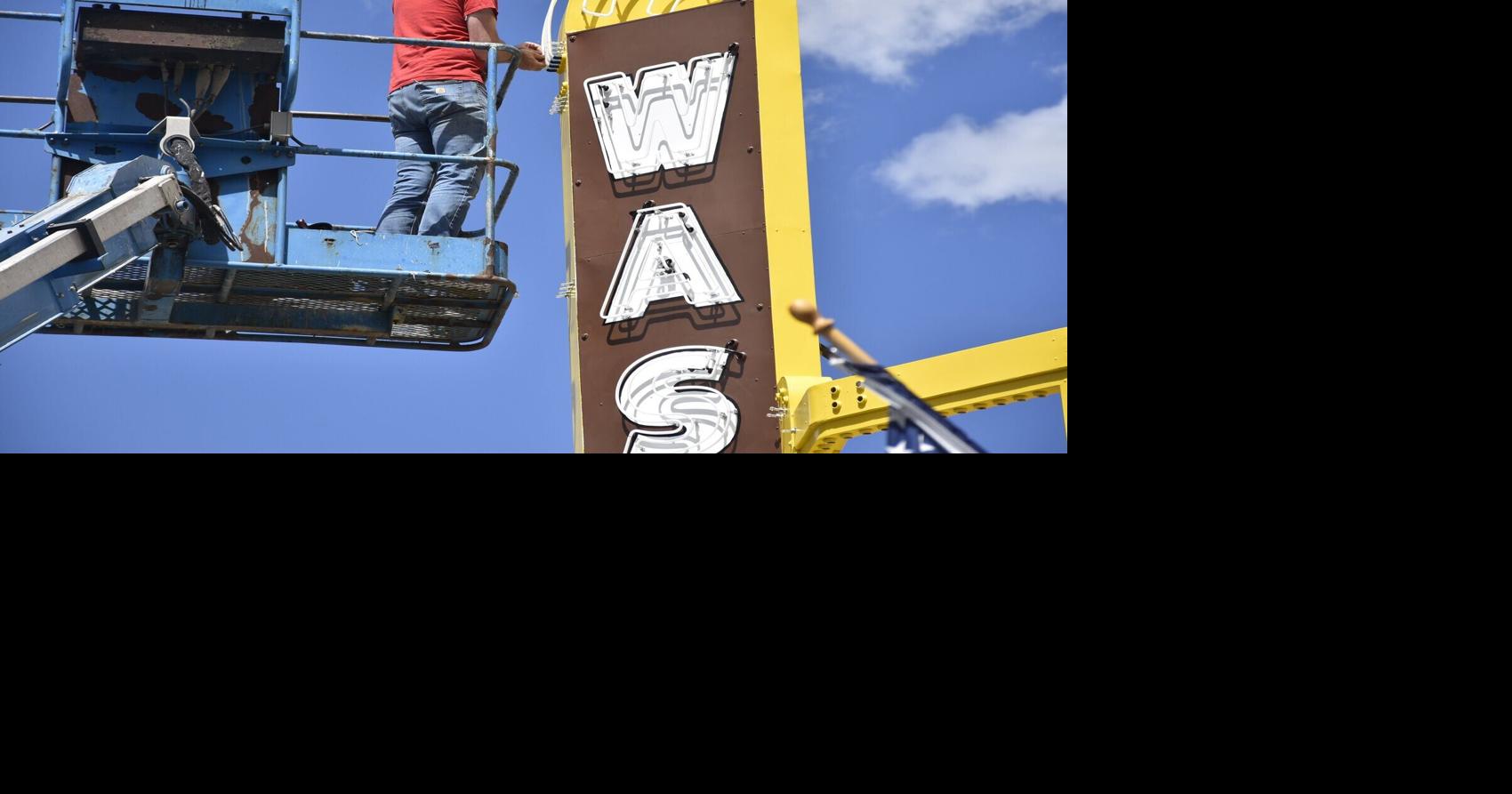 Neon bender returning light and color to Washoe Theatre marquee