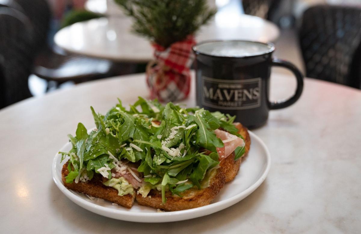 Avocado toast topped with Prosciutto, parmesan, and arugula