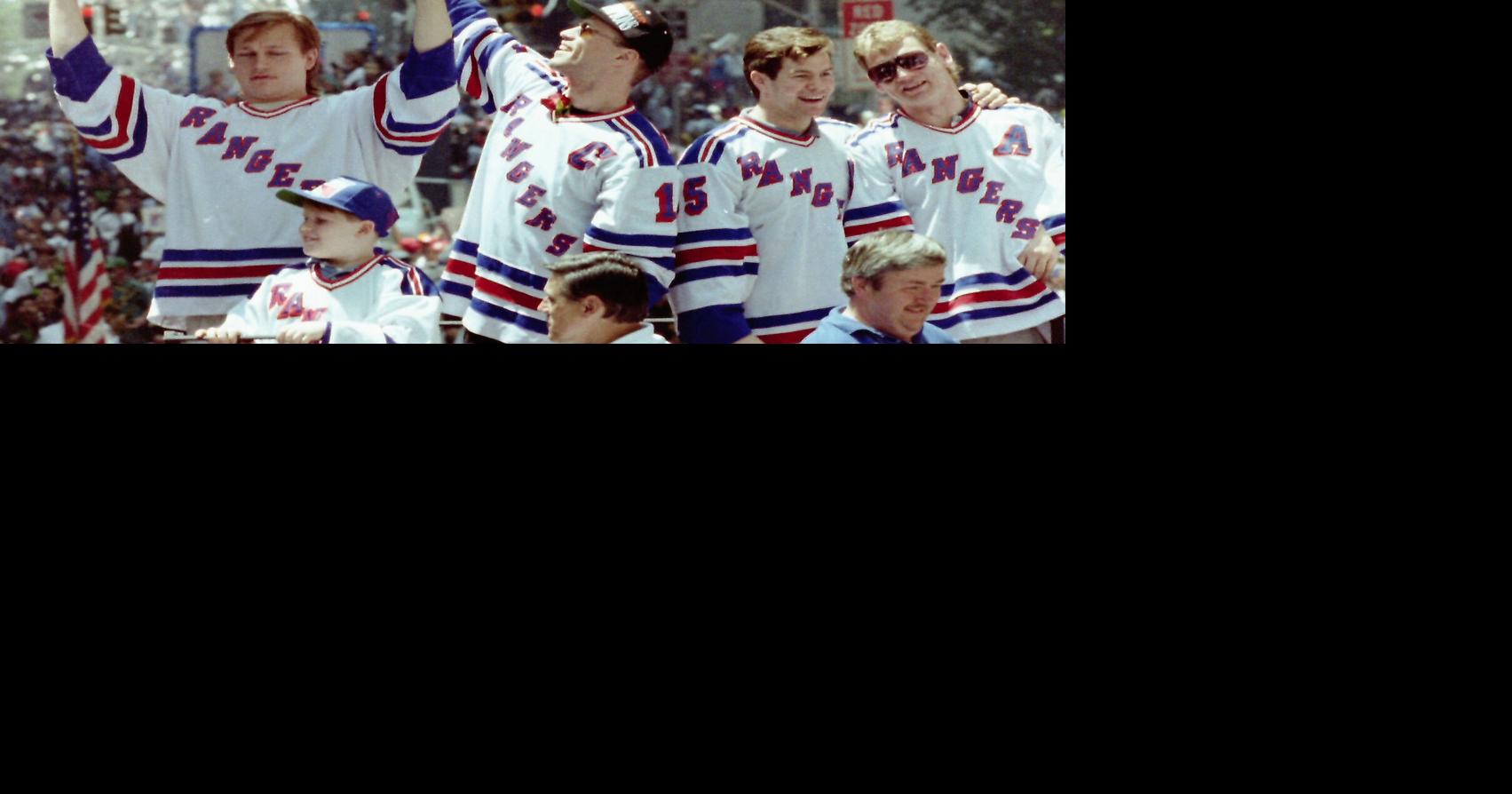 New York Rangers Mark Messier, Adam Graves, Mike Richter, Brian Leetch, Steve Larmer and Kevin Lowe take turns lifting the Stanley Cup on the lead float as over a million fans lined the Canyon of Heroes on Broadway during the Rangers ticker-tape parade June 17, 1994. A few days earlier the Rangers defeated the Vancouver Canucks 3-2 in Game 7 to win the cup.