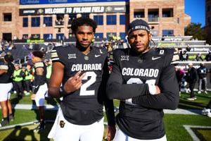 Nov 29, 2024; Boulder, Colorado, USA; Colorado Buffaloes quarterback Shedeur Sanders (2) and safety Shilo Sanders (21) before the game against the Oklahoma State Cowboys at Folsom Field. Mandatory Credit: Ron Chenoy-Imagn Images