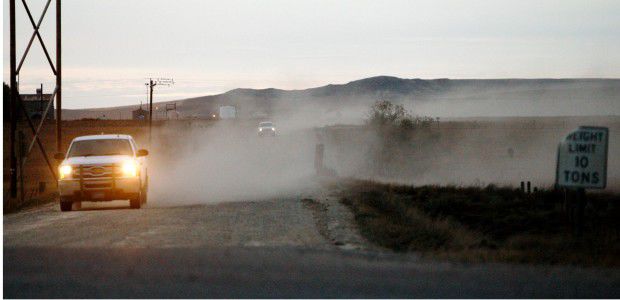 Pickup trucks kick up dust