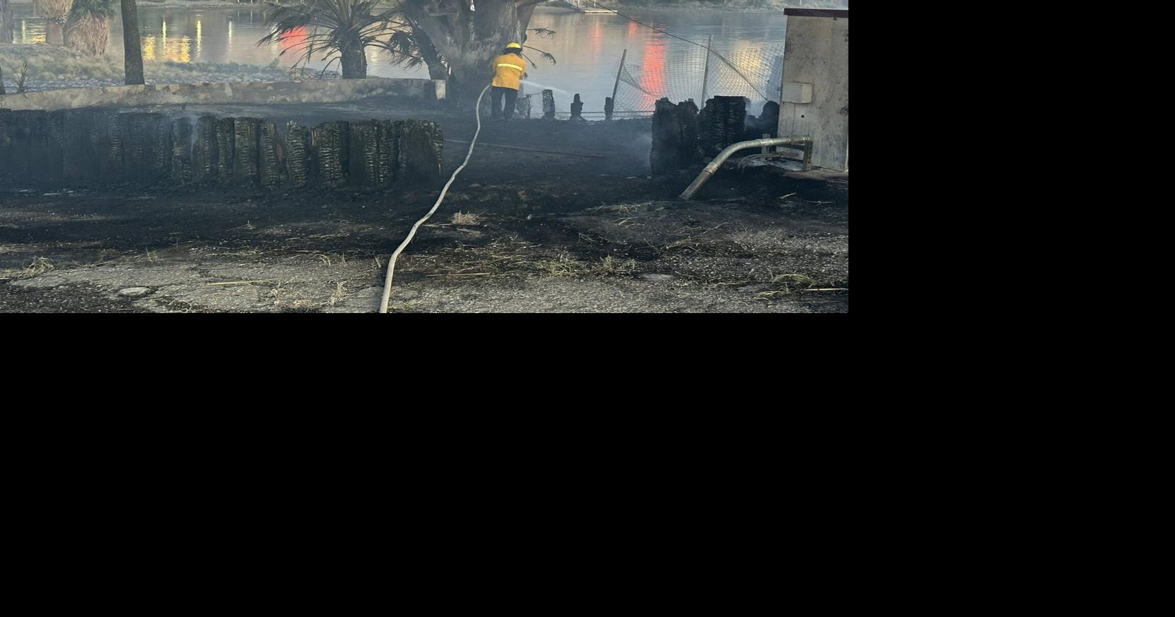 Emergency crews respond early Tuesday to a brush fire near Highway 95 ...