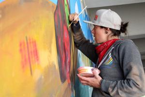 Artist paints finishing touches onto West Main Bridge mural ahead of community unveiling event