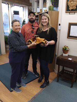 Local residents win a 1915 Chevy wooden model in recent Creative Corner prize drawing