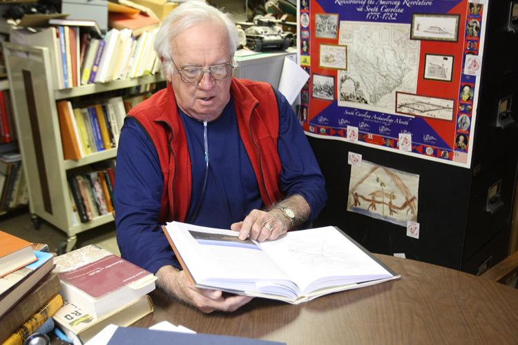 Steve Baker flips through the pages of his book