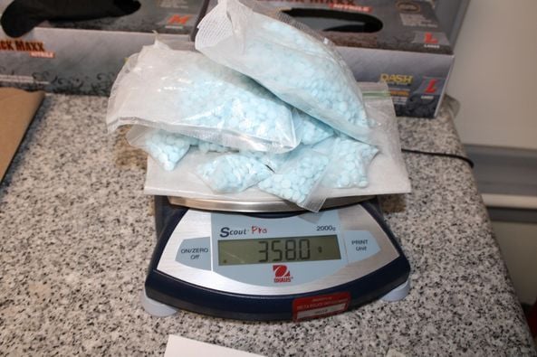 Delta police seize thousands of suspected fentanyl pills, plus suspected meth; guns, cash