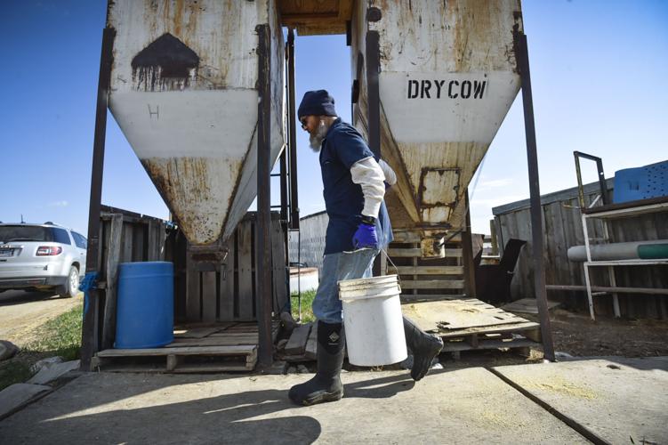 Inmate Mark McGuire fills a grain bucket