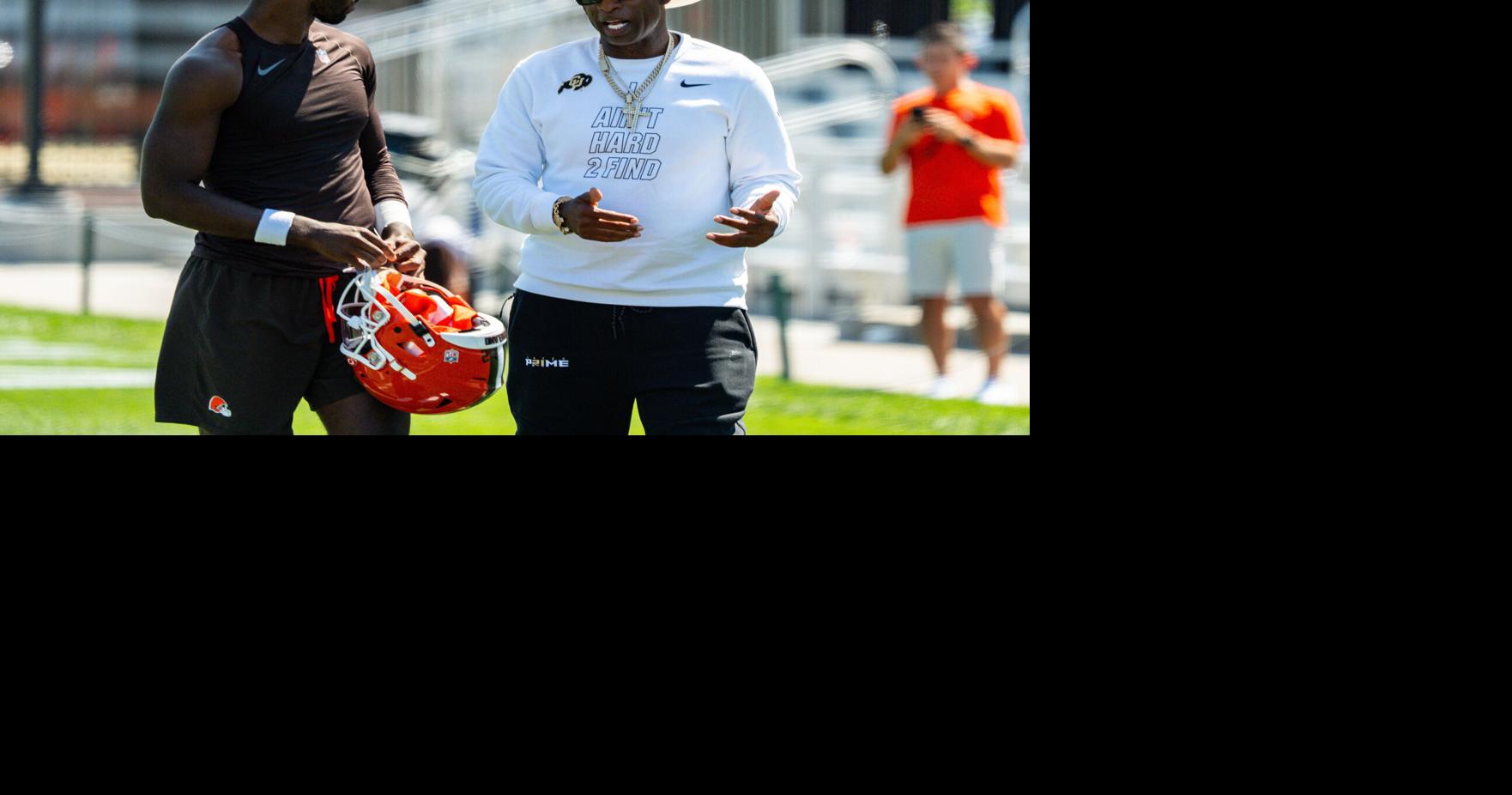 Deion Sanders spends time with his son, Cleveland Browns quarterback Shedeur Sanders (2) at the conclusion of the second day of