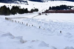 Windrows help contain snowdrifts on windy Mill Creek Road