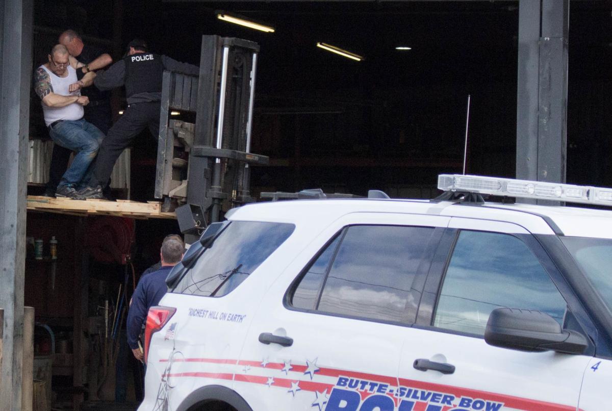 Police use forklift to bring man down from elevated tire storage platform
