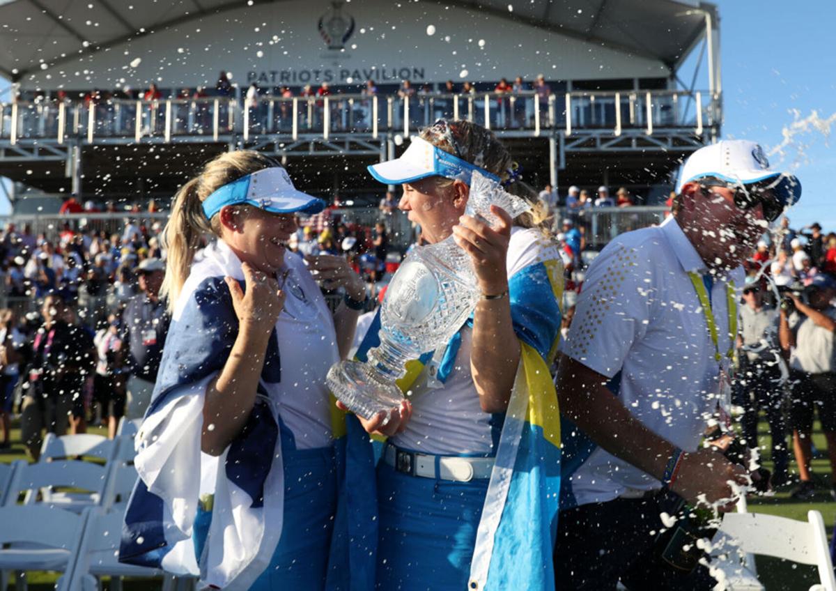 Anna Nordqvist of Team Europe and Madelene Sagstrom of Team Europe celebrate with the Solheim Cup after winning over Team USA during day three of the Solheim Cup at the Inverness Club on September 6, 2021 in Toledo, Ohio.