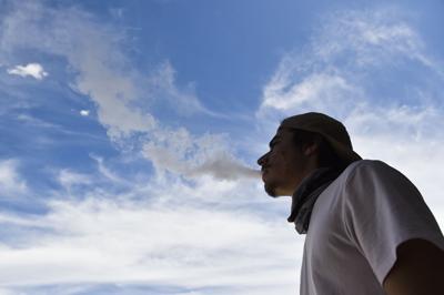 A vaper exhales a cloud of vapor in Helena
