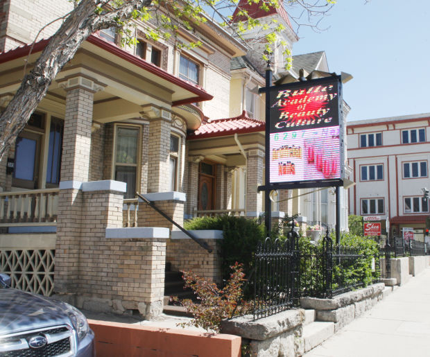 Flashy sign irks neighbor: No laws broken; owner says it stays