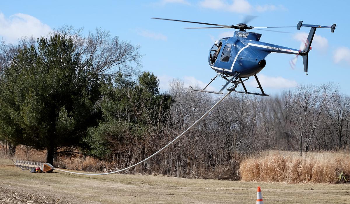 Helicopter uses massive saw to clear rail line Local