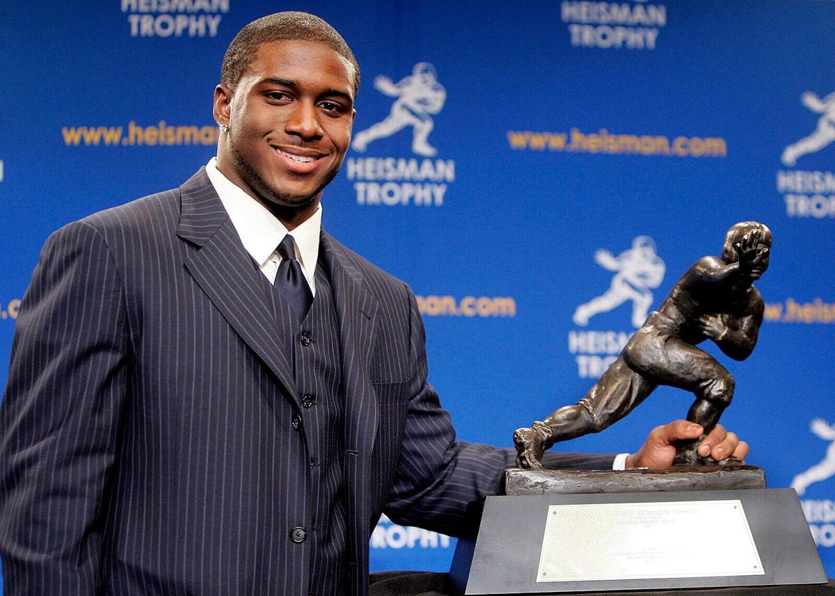 Running back Reggie Bush #5 of the USC Trojans poses with the 2005 Heisman trophy after winning the award at the 71st Annual Heisman Ceremony on Dec. 10, 2005, in New York City.