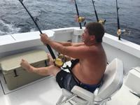 Frank Whirley reels in a 121 pound tuna in the White Marlin Open