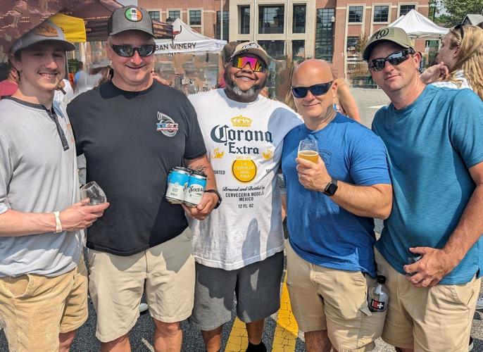 A group of five event attendees pose for a picture in Downtown Centreville.