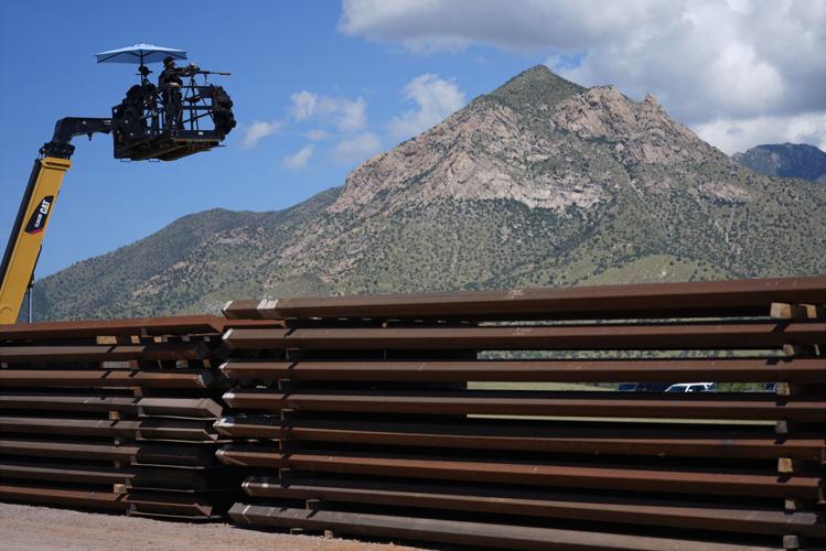 Trump uses a stretch of border wall and a pile of steel beams in ...