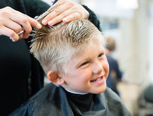 young boy getting a haircut