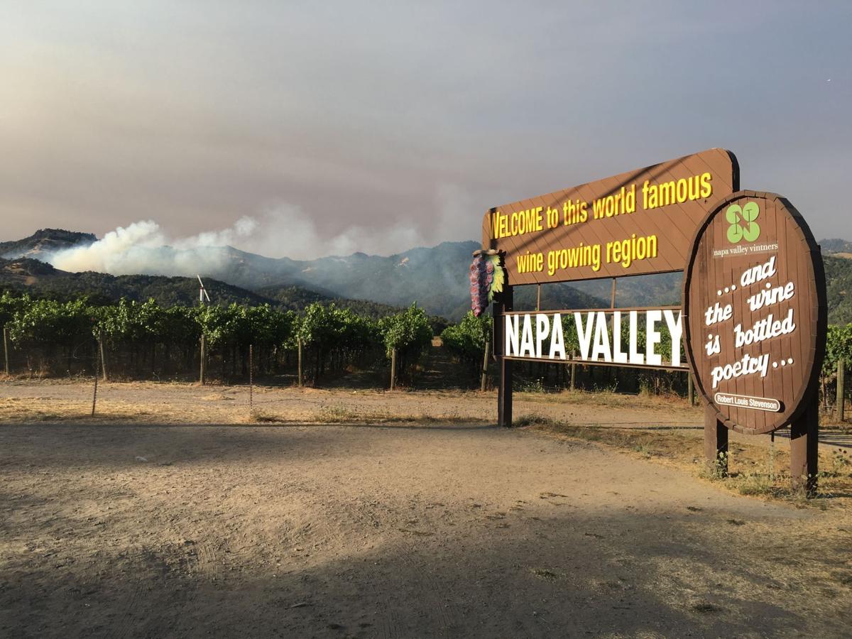 Fire burns in sight of Napa Valley welcome sign