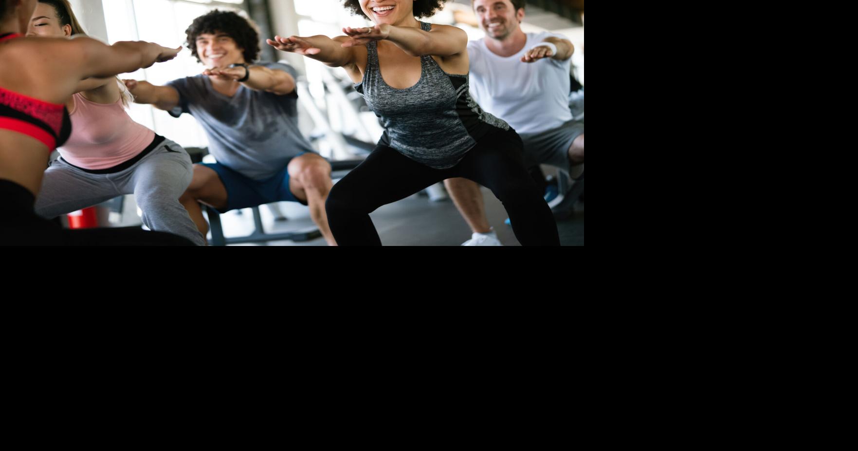 Group of healthy fit people at the gym exercising