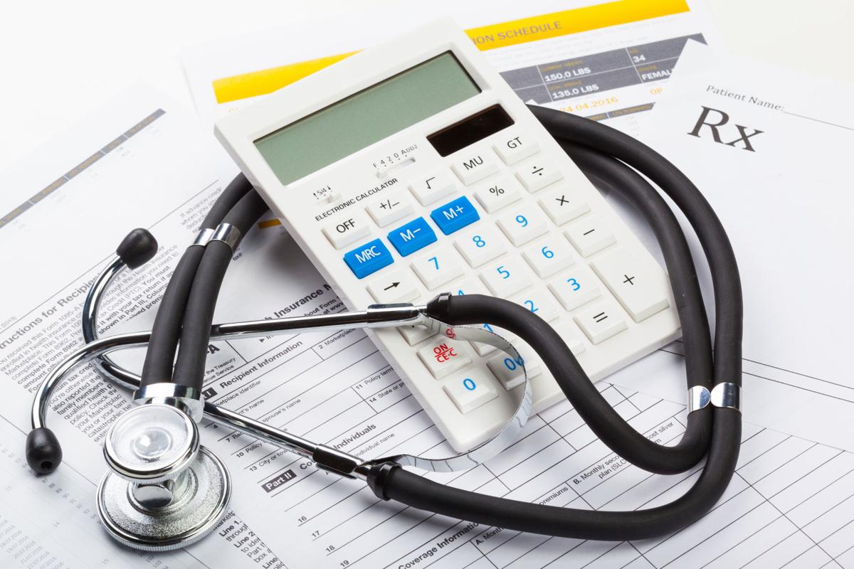 Health care costs. Stethoscope and calculator