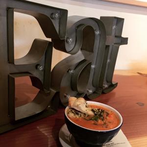 Eat sign next to cup of soup