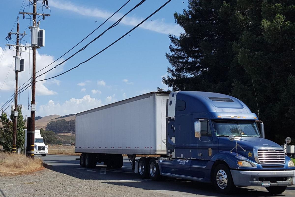 Utility poles and commercial truck on Green Island Road (copy)