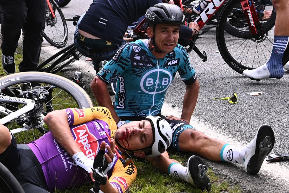 Team B&B KTM's Bryan Coquard of France, right, and a Team Alpecin Fenix' rider lie on the ground after crashing during the first stage of the 108th edition of the Tour de France cycling race, 197 km between Brest and Landerneau, on Saturday, June 26, 2021.