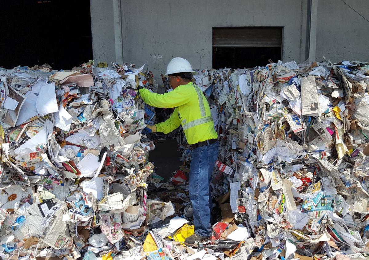 Worker at Napa Recycling & Waste Services pulling plastics