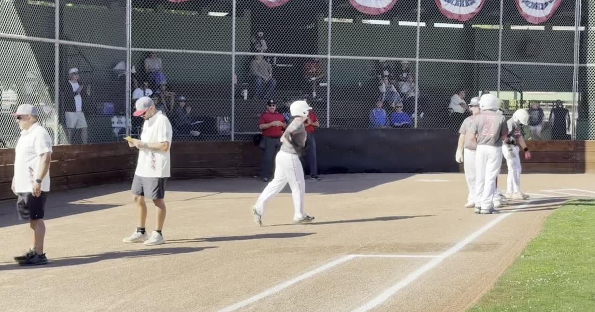 The American Canyon and St. Helena Little League Intermediate All-Stars are introduced, and St. Helena's Gabe Devore catches a Sergio Cruz popup