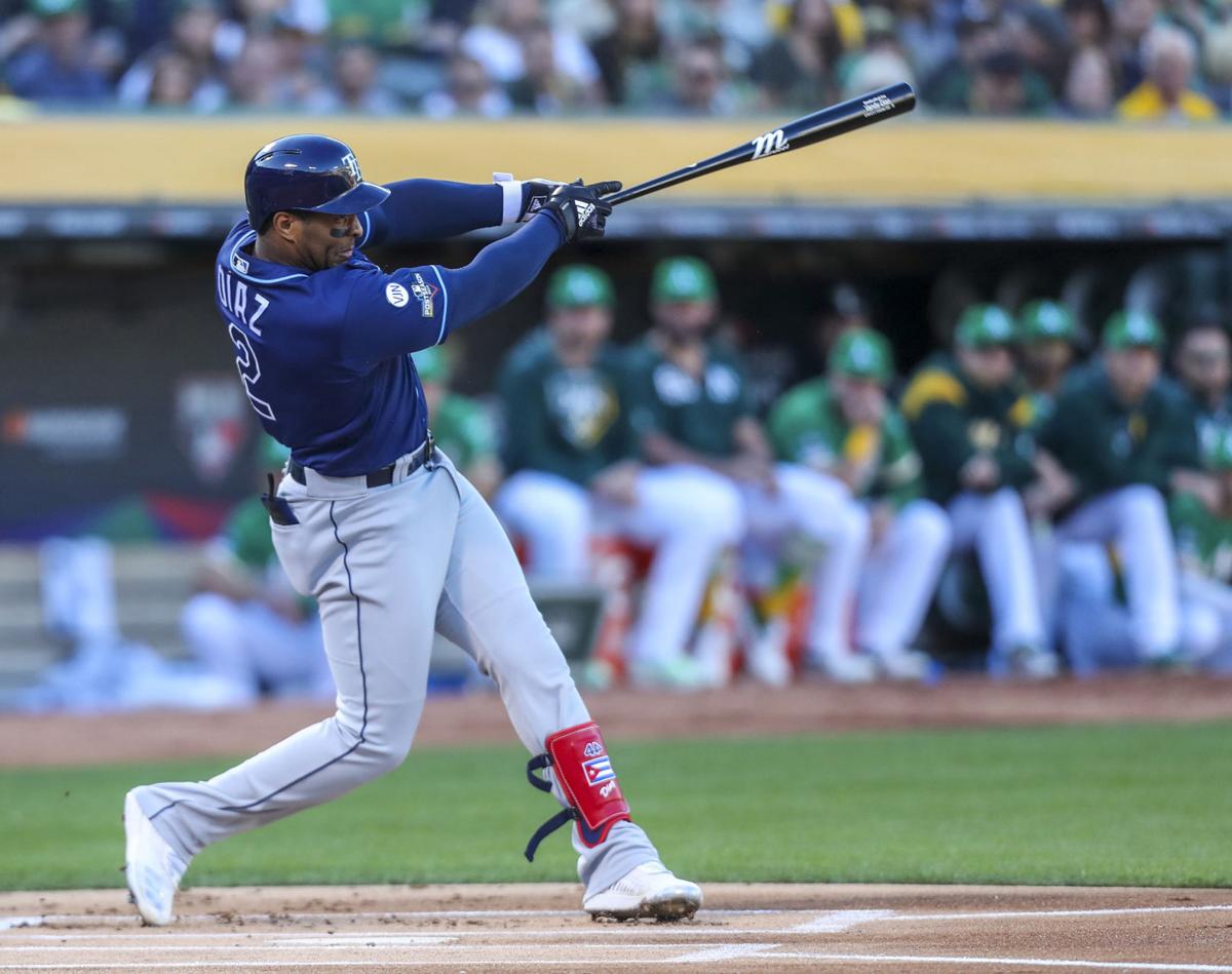 The Tampa Bay Rays' Yandy Diaz connects for a solo home run in the first inning against the Oakland Athletics in the American League Wild Card game on October 2, 2019, at the Oakland Coliseum in Oakland, Calif.