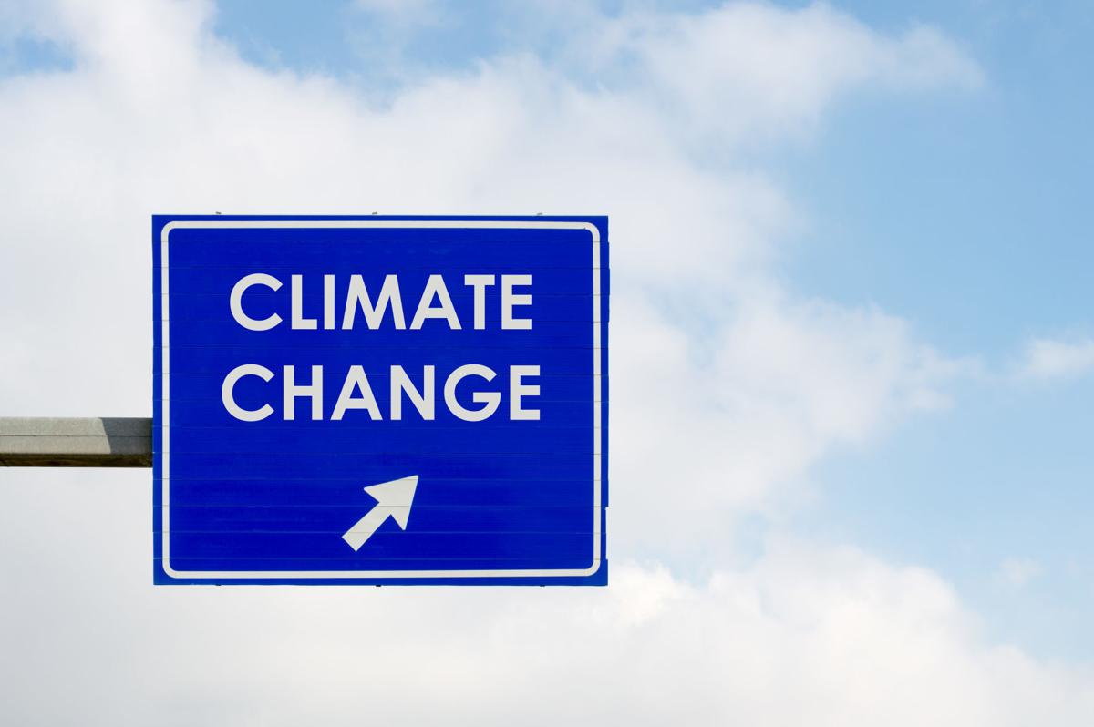 Climate Change words displayed on blue road sign