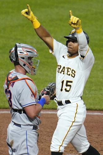 Pittsburgh Pirates' Adam Frazier, right, stands on third base next