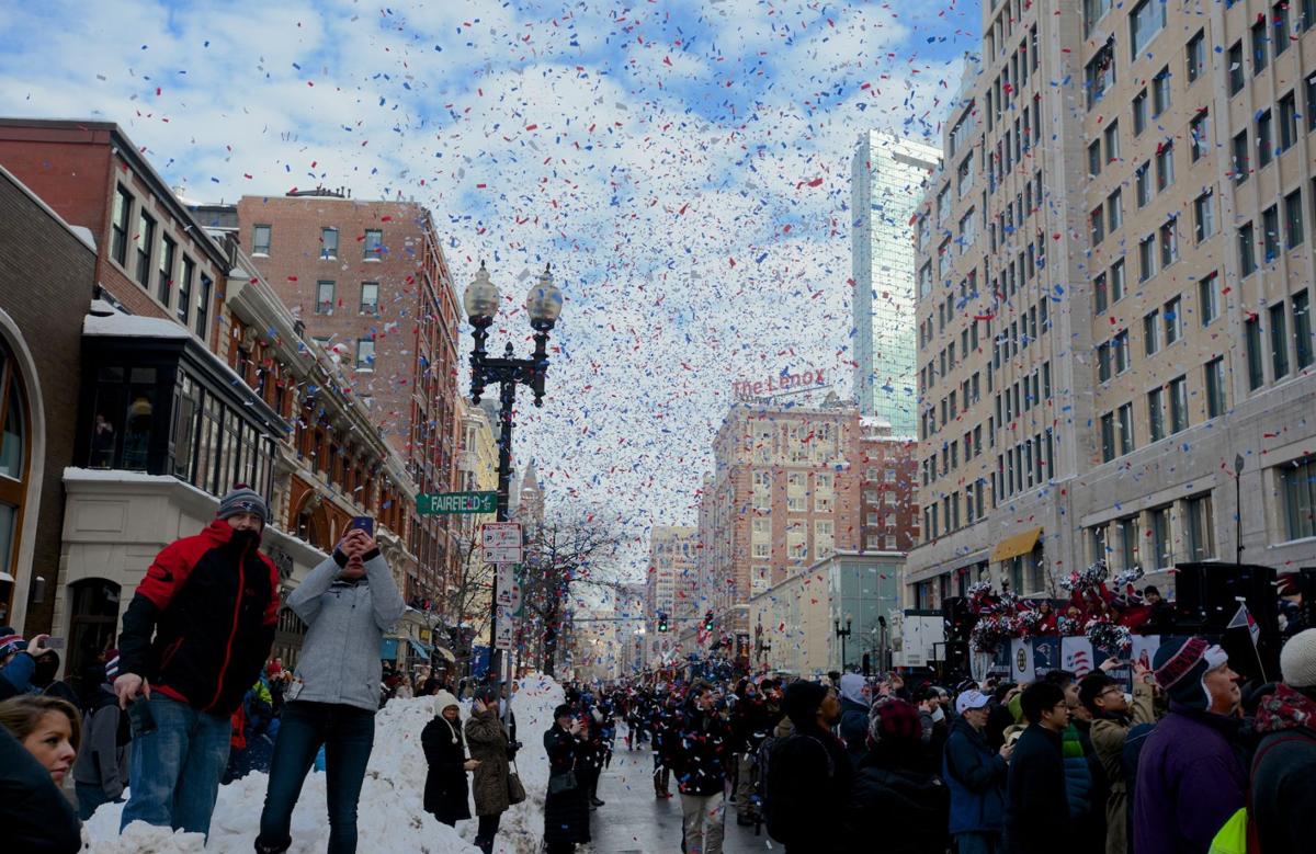 Confetti rains down on Boylston Street as the New England Patriots' celebratory parade gets underway.
