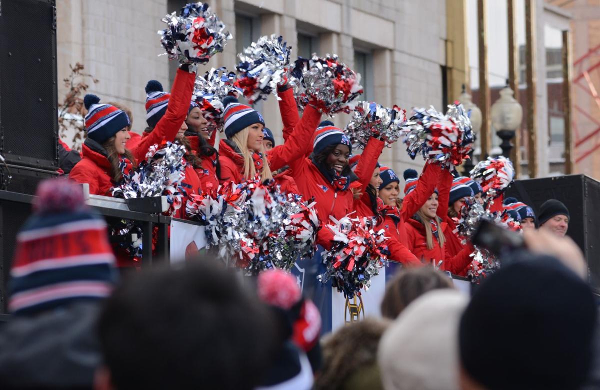 The New England Patriots cheerleaders pump the crowd up on one of the first floats down Boylston Street.