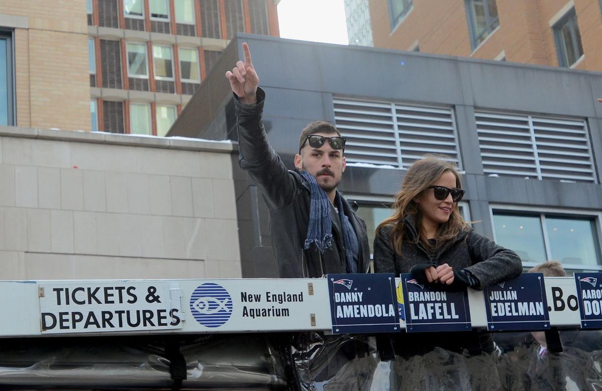 Patriots Wide Receiver Danny Amendola waves to fans along Boylston Street during the team's celebratory parade.