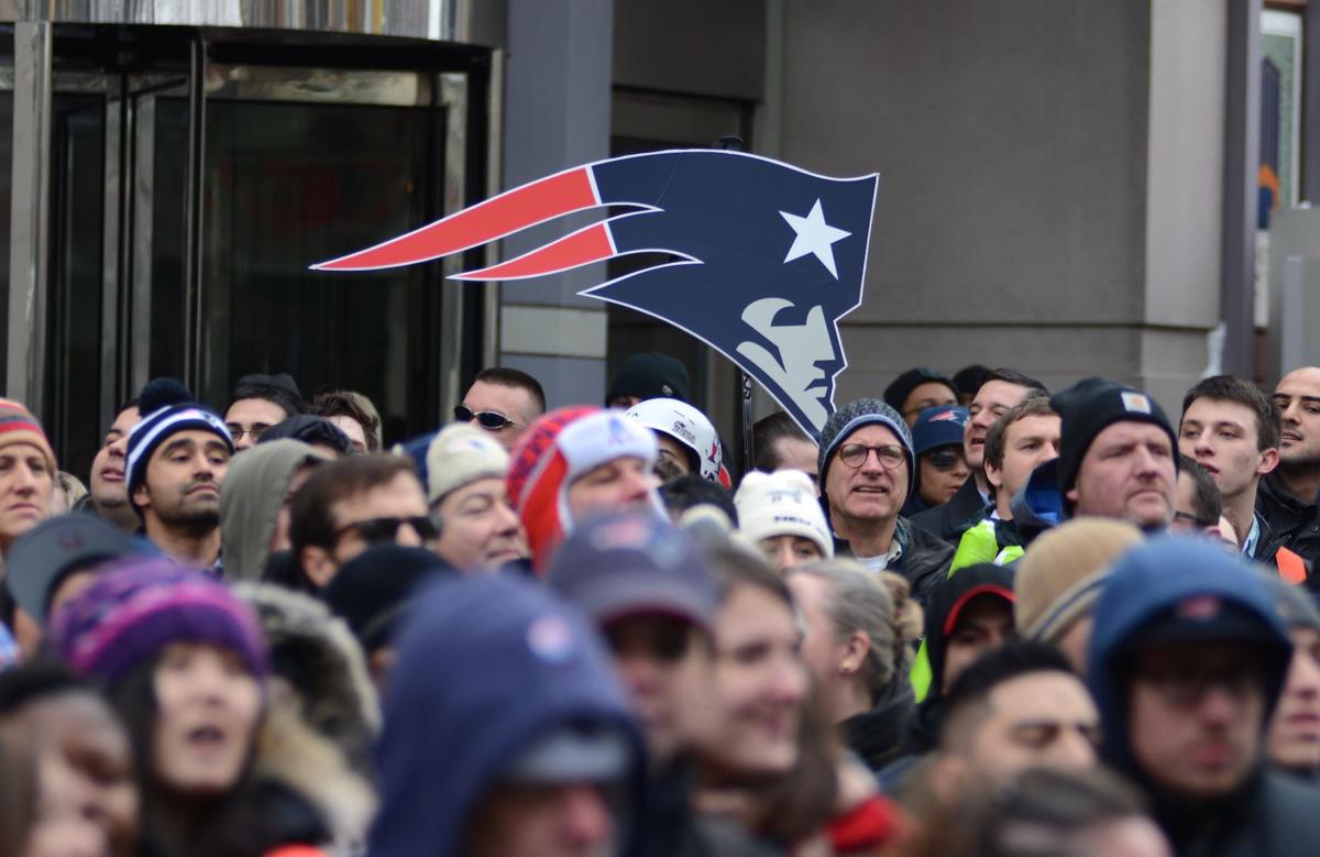 Patriots fans pack the sidewalk in front of the Prudential Center nearly an hour before the parade to celebrate the team's Super Bowl win begins.